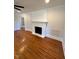 Spacious living room featuring hardwood floors and a classic fireplace at 445 N Dunn St, Angier, NC 27501