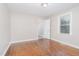 Bright bedroom featuring hardwood floors and access to a bathroom at 4505 Laymans Chapel Rd, Durham, NC 27704