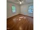 Bright bedroom with hardwood floors and two windows at 465 N Dunn St, Angier, NC 27501