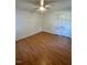 Spacious bedroom with hardwood floors and ceiling fan at 465 N Dunn St, Angier, NC 27501