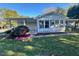 Ranch home with sunroom and mature landscaping at 465 N Dunn St, Angier, NC 27501