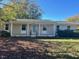 Charming ranch home with a covered porch and well-maintained lawn at 465 N Dunn St, Angier, NC 27501
