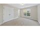 Spacious bedroom with neutral carpeting, large closet, and window with blinds at 10132 Blackwell Dr, Raleigh, NC 27617