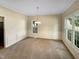 Bright dining room with neutral walls, carpet flooring, and a chandelier at 104 Longbridge Dr, Cary, NC 27518