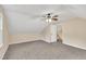 Large carpeted bedroom with vaulted ceilings, natural light, and easy access to stairs at 110 Modena Dr, Cary, NC 27513