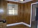 Dining room with wood paneling and window at 118 Southern Ave, Henderson, NC 27536