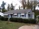 Front view of the light blue house with landscaping and a driveway at 118 Southern Ave, Henderson, NC 27536