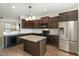 Kitchen with dark wood cabinets, granite countertops, and stainless steel appliances at 15 Axum Rd, Willow Springs, NC 27592