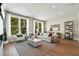 Bright living room with hardwood floors, large windows, and comfy furniture at 1500 Village Hall Ln # 39, Wake Forest, NC 27587