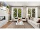 Modern living room with hardwood floors, fireplace, and ample natural light at 1500 Village Hall Ln # 39, Wake Forest, NC 27587