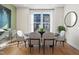 Bright dining room with large windows, round table, and four grey chairs at 1508 Village Hall Ln, Wake Forest, NC 27587
