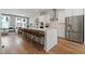Modern kitchen with white cabinets, stainless steel appliances, and an island with seating at 1508 Village Hall Ln, Wake Forest, NC 27587