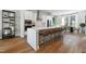 Modern kitchen with white cabinets, island seating, stainless steel appliances, and hardwood floors at 1508 Village Hall Ln, Wake Forest, NC 27587