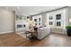 Light and airy living room with hardwood floors, fireplace, and large windows at 1508 Village Hall Ln, Wake Forest, NC 27587