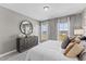 Bedroom with large windows and dresser at 1508 Village Hall Ln, Wake Forest, NC 27587