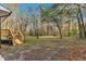 Private backyard with a wooden deck and trees at 1518 Parks Village Rd, Zebulon, NC 27597