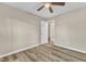 Bright bedroom with wood-look floors and ceiling fan at 1518 Parks Village Rd, Zebulon, NC 27597