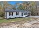 Newly renovated single story home with gray accents and a carport at 1518 Parks Village Rd, Zebulon, NC 27597