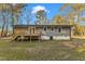 Gray house exterior with a deck and yard at 1518 Parks Village Rd, Zebulon, NC 27597