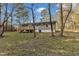 Gray house with deck, spacious backyard, and tree-lined surroundings at 1518 Parks Village Rd, Zebulon, NC 27597