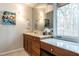 Modern bathroom with dual vanity, marble countertops, and large window at 4824 Sandberry Ln, Raleigh, NC 27613