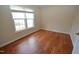 Bright bedroom with hardwood floors and large window at 108 Long Shadow Pl, Durham, NC 27713