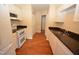 View of kitchen with white appliances and wood flooring at 108 Long Shadow Pl, Durham, NC 27713