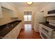 Well-equipped kitchen featuring granite countertops and white cabinets at 108 Long Shadow Pl, Durham, NC 27713