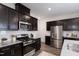 Stainless steel appliances and dark brown cabinets in kitchen at 1168 Maple Branch Cir, Graham, NC 27253