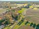 Aerial view of a house and surrounding land with a road nearby at 138 Gold Sand Rd, Louisburg, NC 27549