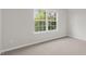 Bright bedroom featuring a large window and neutral wall colors at 1680 Abberly Pl, Graham, NC 27253