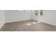 Spacious bedroom with large windows and wood-look flooring at 1680 Abberly Pl, Graham, NC 27253