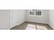 Well-lit bedroom with wood-look flooring and a window at 1680 Abberly Pl, Graham, NC 27253