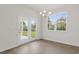 Bright dining area with hardwood floors, large windows, and access to a patio at 1680 Abberly Pl, Graham, NC 27253