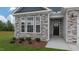 Inviting front entrance with stone facade, dark door, and landscaping at 1680 Abberly Pl, Graham, NC 27253