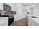 Modern kitchen with stainless steel appliances and white cabinetry at 1680 Abberly Pl, Graham, NC 27253