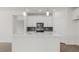 Modern kitchen featuring white cabinets, quartz countertops, and stainless steel appliances at 1680 Abberly Pl, Graham, NC 27253