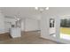 Open concept kitchen with island and view into living room at 1680 Abberly Pl, Graham, NC 27253