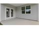 Covered patio with double doors and window overlooking backyard at 1680 Abberly Pl, Graham, NC 27253