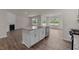 Open concept kitchen with island and hardwood floors at 2508 Trevana Way, Graham, NC 27253