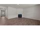 Living room with corner fireplace and wood-look flooring at 2508 Trevana Way, Graham, NC 27253