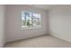 Bright bedroom with carpeted floor and large window at 2508 Trevana Way, Graham, NC 27253