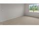 Bright bedroom with neutral walls and carpet, featuring a large window at 2508 Trevana Way, Graham, NC 27253