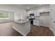 Kitchen with island, granite countertops, and white cabinets at 2508 Trevana Way, Graham, NC 27253
