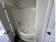 Bathroom with a corner bathtub and gray vinyl flooring at 305 Pebblestone Dr, Durham, NC 27703