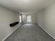 Spacious bedroom with gray carpeting and a wall-mounted shelf at 305 Pebblestone Dr, Durham, NC 27703