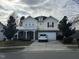 Two-story house with brick and siding, attached garage, and landscaping at 305 Pebblestone Dr, Durham, NC 27703