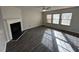 Living room featuring hardwood floors, fireplace, and large windows at 305 Pebblestone Dr, Durham, NC 27703
