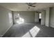 Main bedroom with gray carpeting, ceiling fan, and access to a private bathroom at 305 Pebblestone Dr, Durham, NC 27703