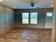 Bright living room with large windows, wood-look floors, and an accent wall at 332 Mill Creek Church Rd, Newton Grove, NC 28366